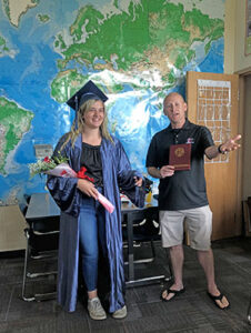 Willamette H.S. Principal Dan Hedberg does the honors as Amethyst receives her high school diploma one academic year early.
